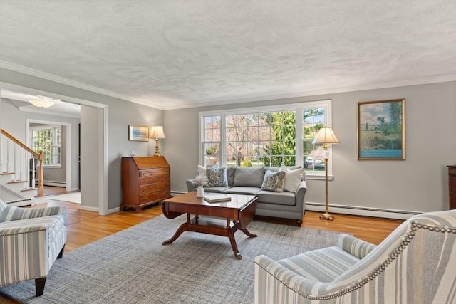 living area featuring a textured ceiling, plenty of natural light, a baseboard heating unit, and wood finished floors