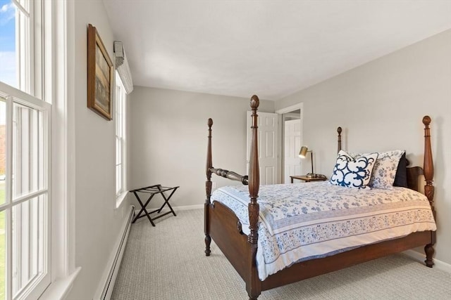 bedroom featuring carpet floors, baseboards, and a baseboard heating unit