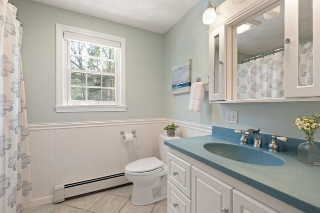 bathroom featuring a baseboard radiator, a wainscoted wall, toilet, and tile patterned floors
