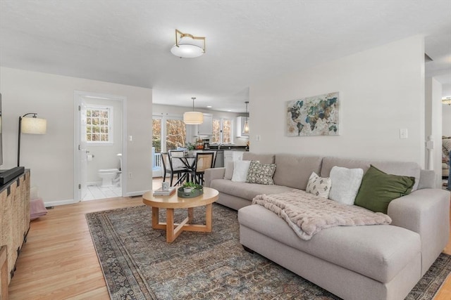 living room with light wood finished floors and baseboards