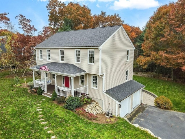 view of front of property with a garage, driveway, a shingled roof, a porch, and a front lawn