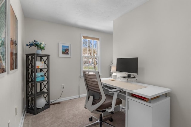 office space featuring light colored carpet and baseboards