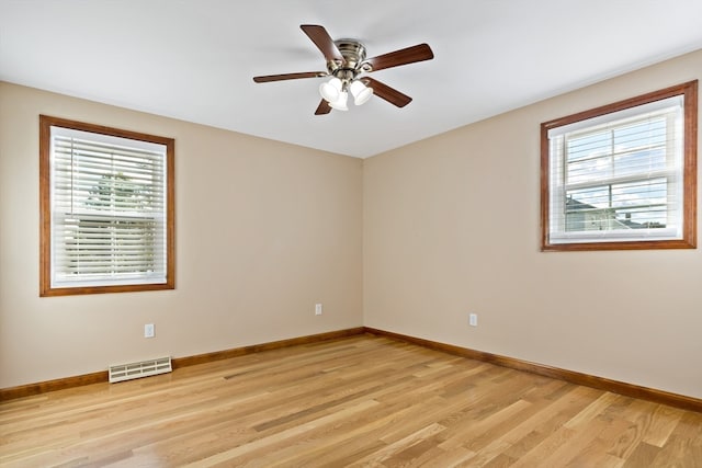 unfurnished room featuring light wood-type flooring, a healthy amount of sunlight, and ceiling fan