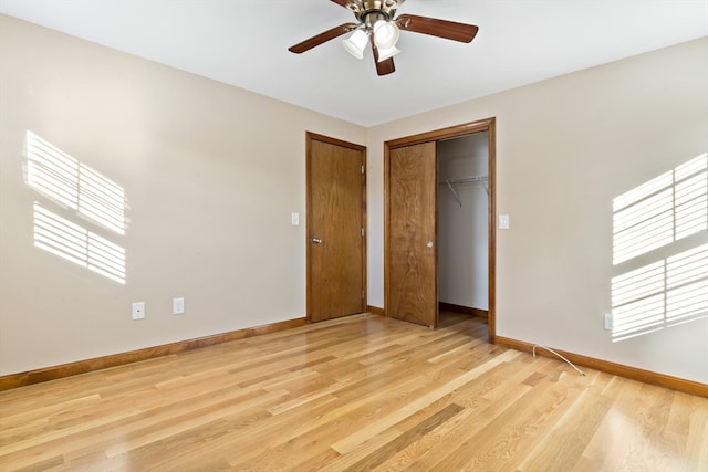 unfurnished bedroom featuring light hardwood / wood-style floors, multiple windows, and ceiling fan