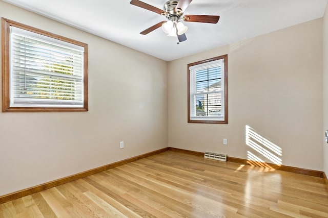 spare room with light wood-type flooring and ceiling fan