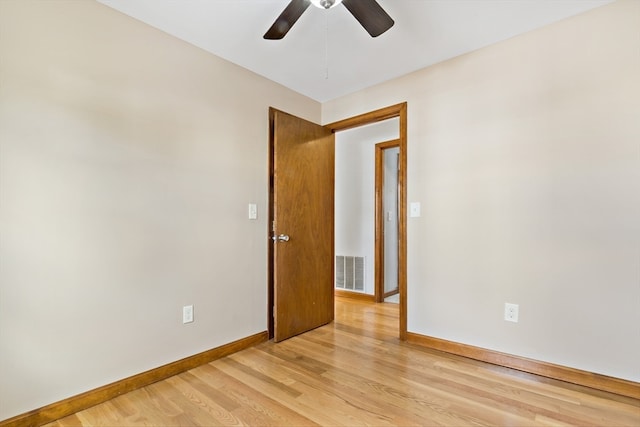 unfurnished room with light wood-type flooring and ceiling fan