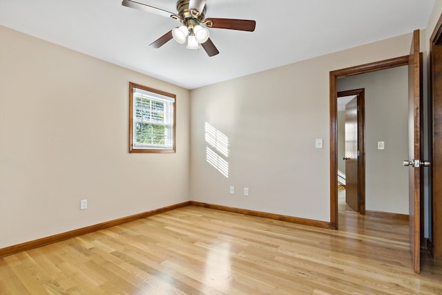 spare room featuring light wood-type flooring and ceiling fan