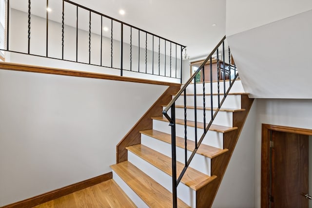 stairway with hardwood / wood-style flooring