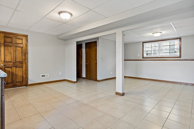 basement with a paneled ceiling