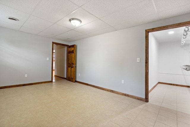 unfurnished room with a drop ceiling