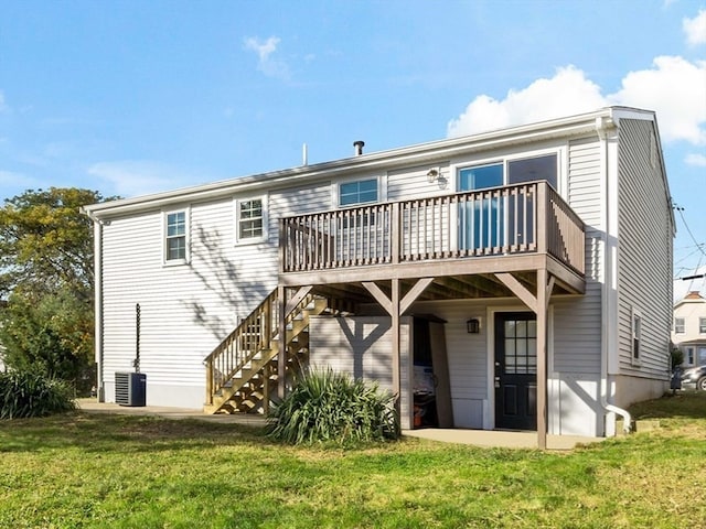 rear view of house with a deck and a lawn