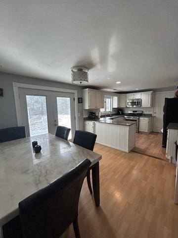 dining area featuring french doors, recessed lighting, and light wood-style floors