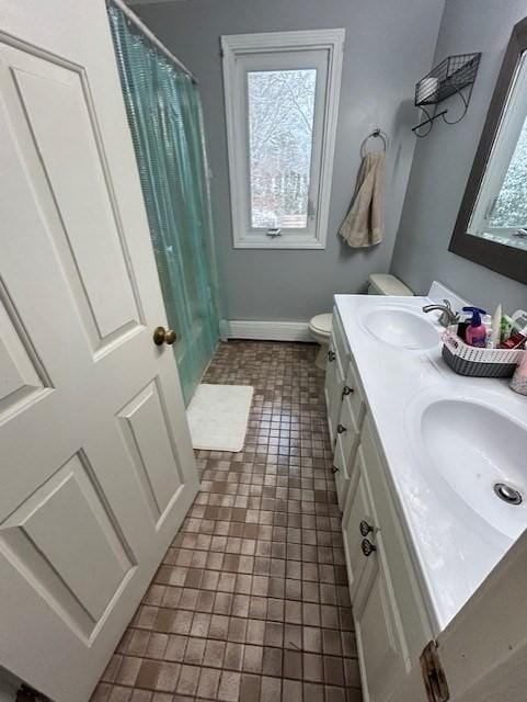 bathroom featuring plenty of natural light, a sink, and double vanity