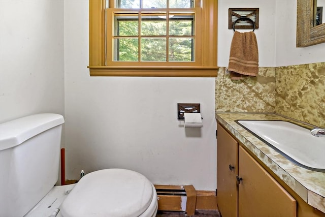 92 Rocky Hill Rd, Rehoboth, MA 02769 - bathroom featuring toilet, vanity, a baseboard radiator, and decorative backsplash