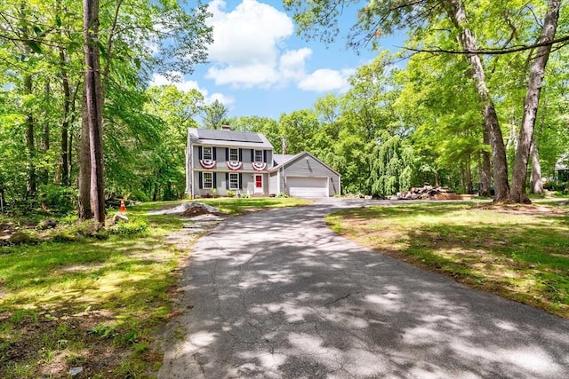 92 Rocky Hill Rd, Rehoboth, MA 02769 - colonial home with driveway, roof mounted solar panels, a garage, and a chimney
