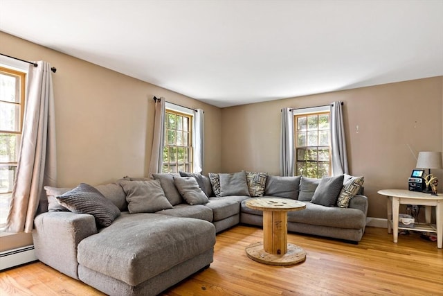 92 Rocky Hill Rd, Rehoboth, MA 02769 - living area with plenty of natural light, light wood-style floors, and a baseboard radiator