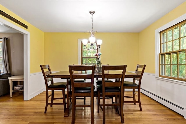 92 Rocky Hill Rd, Rehoboth, MA 02769 - dining space featuring a baseboard radiator, light wood finished floors, a chandelier, and wainscoting