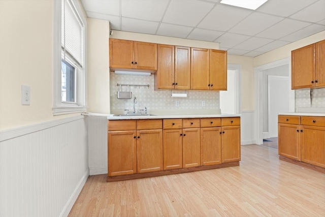 12 Porter St, Everett, MA 02149 - kitchen with light countertops, light wood finished floors, backsplash, a paneled ceiling, and wainscoting