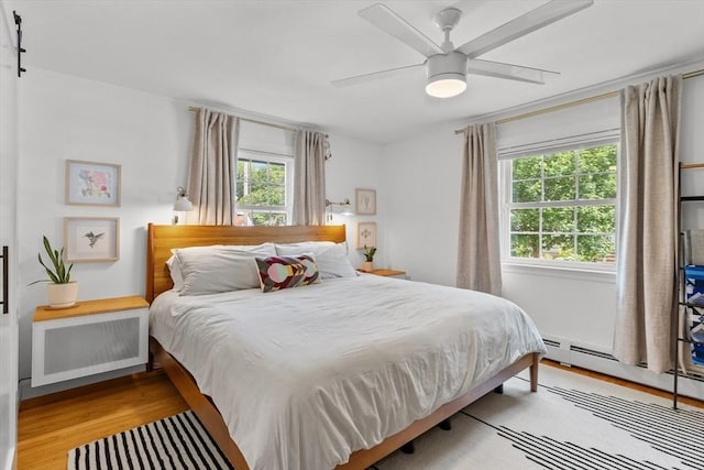 6 Hayes Rd, Salem, MA 01970 - bedroom with wood finished floors, a baseboard heating unit, and ceiling fan