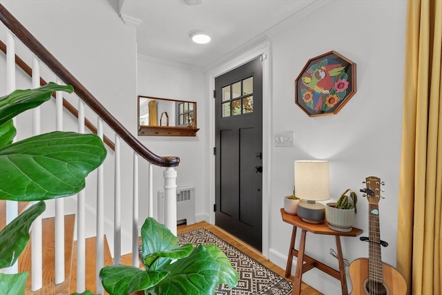 6 Hayes Rd, Salem, MA 01970 - foyer featuring radiator, wood finished floors, stairs, and crown molding