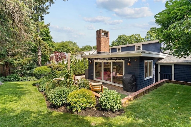 6 Hayes Rd, Salem, MA 01970 - back of house featuring a chimney, a yard, and a patio