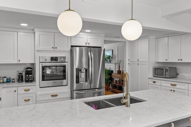 6 Hayes Rd, Salem, MA 01970 - kitchen featuring appliances with stainless steel finishes, white cabinets, recessed lighting, light stone countertops, and pendant lighting
