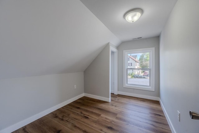 46 Lyons St, Lowell, MA 01852 - additional living space with lofted ceiling, baseboards, and dark wood-type flooring
