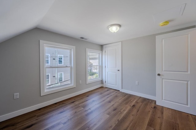 46 Lyons St, Lowell, MA 01852 - unfurnished bedroom featuring dark wood-style floors, baseboards, and vaulted ceiling