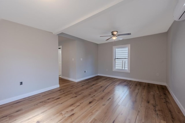 46 Lyons St, Lowell, MA 01852 - spare room with a wall mounted air conditioner, ceiling fan, wood finished floors, and baseboards