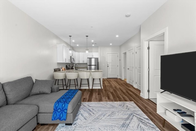living room featuring recessed lighting and dark wood-type flooring