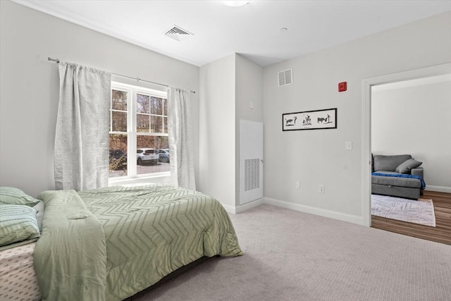 bedroom with baseboards, carpet flooring, and visible vents