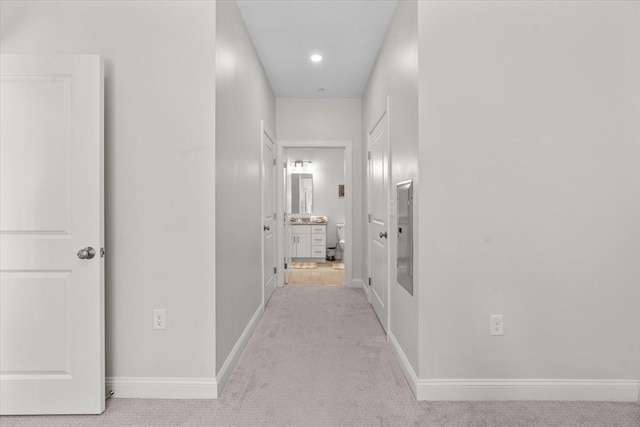 hall with baseboards, carpet, and recessed lighting