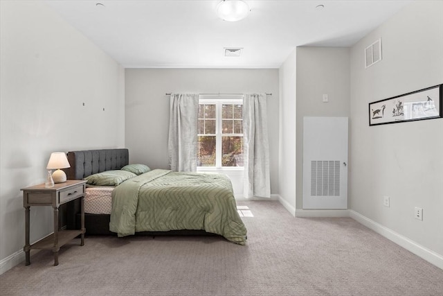 bedroom with light colored carpet, baseboards, and visible vents