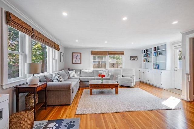 living area with light wood-style floors, recessed lighting, and a healthy amount of sunlight