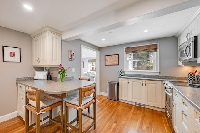 kitchen with stainless steel appliances, recessed lighting, light wood-style flooring, and visible vents