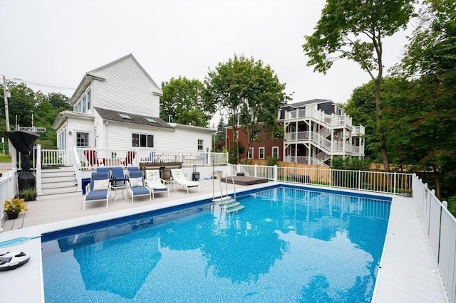 view of swimming pool with fence, a patio area, and a wooden deck