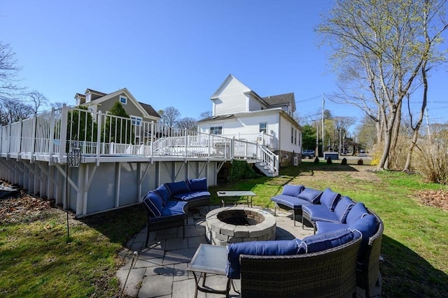 view of patio / terrace with an outdoor living space with a fire pit, a wooden deck, a covered pool, and stairway