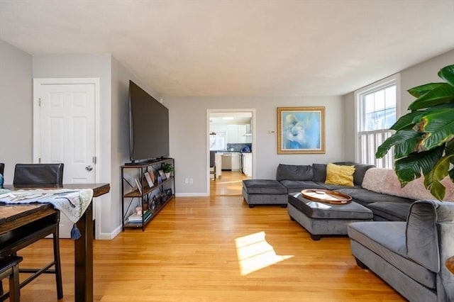 living room featuring light wood-type flooring and baseboards