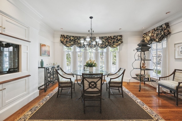 dining room with a chandelier, plenty of natural light, crown molding, and dark hardwood / wood-style floors