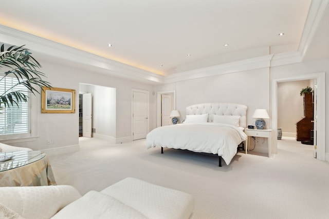 carpeted bedroom featuring crown molding and a tray ceiling