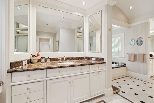 bathroom featuring ornamental molding, tile flooring, vanity, and a tub