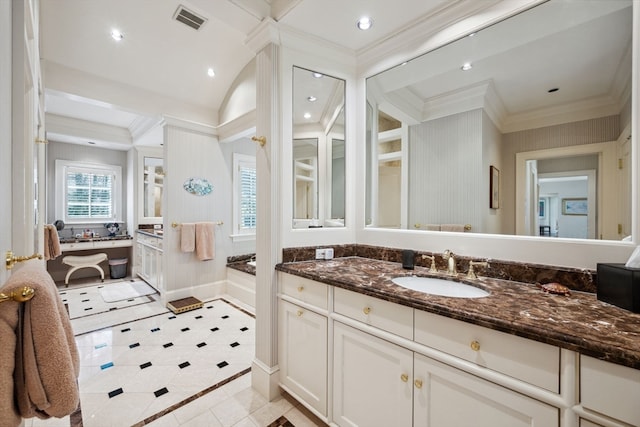 bathroom with tile flooring, vanity, and crown molding