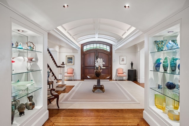 entrance foyer featuring hardwood / wood-style floors and lofted ceiling