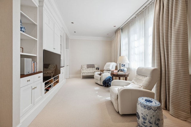 carpeted living room with ornamental molding