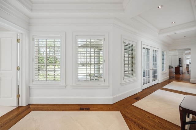 interior space with beamed ceiling, french doors, dark wood-type flooring, and crown molding