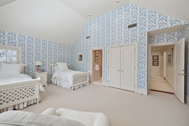 bedroom with carpet and high vaulted ceiling