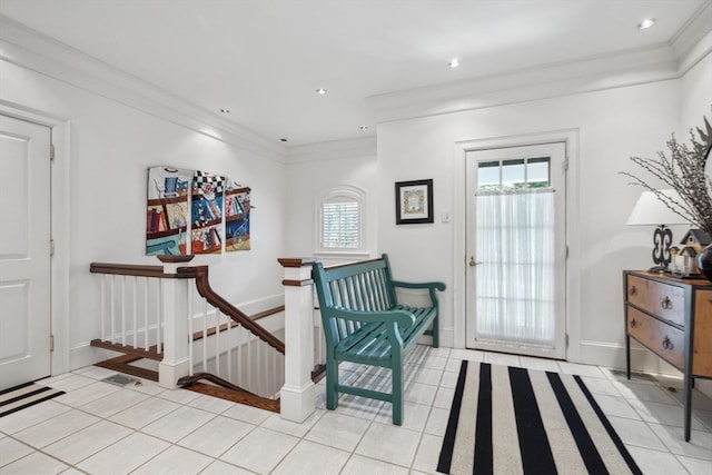 living area featuring plenty of natural light, crown molding, and light tile floors