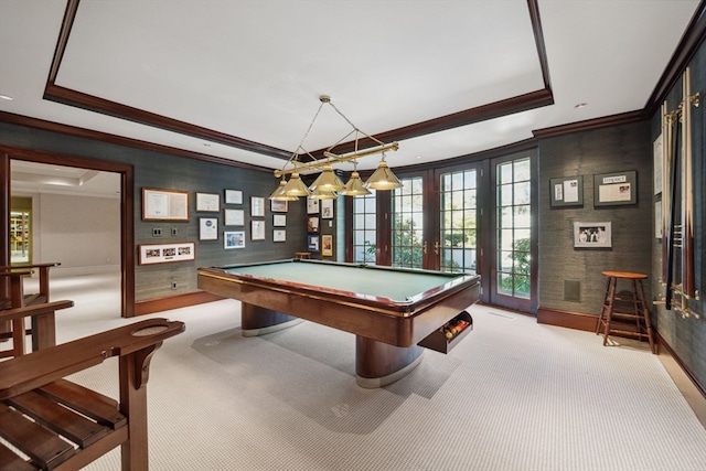 recreation room with light colored carpet, pool table, and a tray ceiling