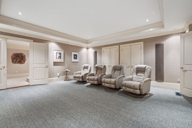 cinema room featuring ornamental molding, carpet floors, and a tray ceiling