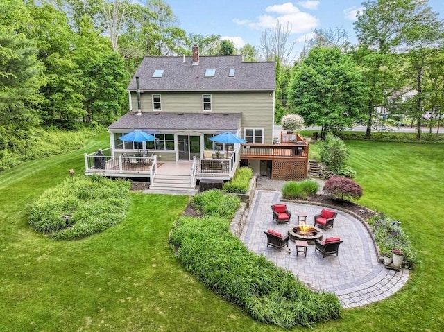 2470 W St, Wrentham, MA 02093 - rear view of property with a fire pit, a patio, a wooden deck, and a lawn